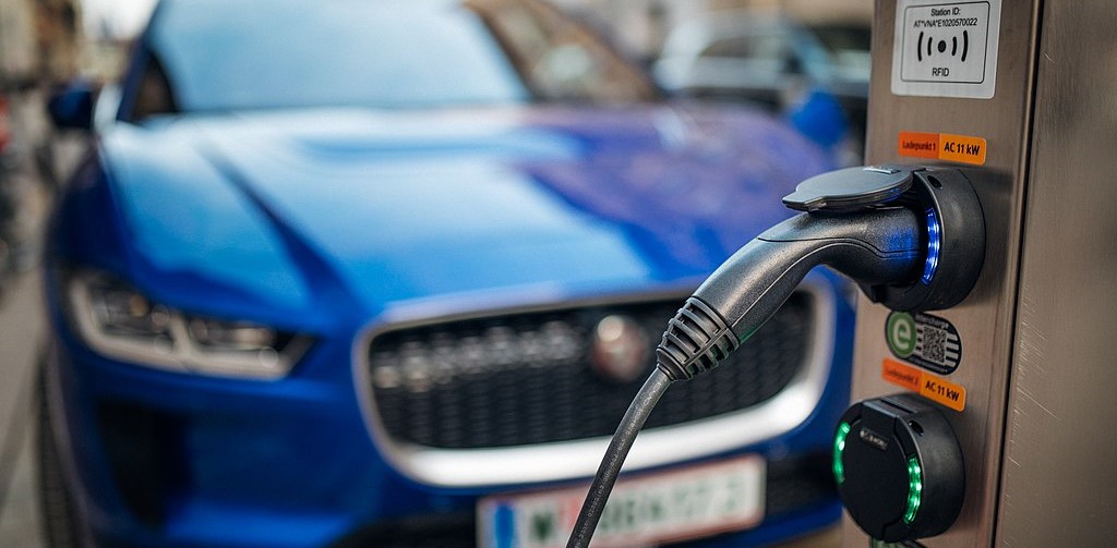 blue car at ev charging station